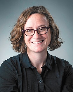 Photo of Jessica Allen wearing a dark shirt and glasses.