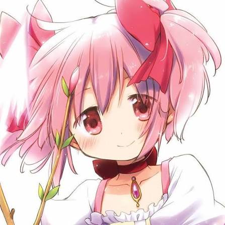 A picture of a pink haired girl in pigtails smiling.