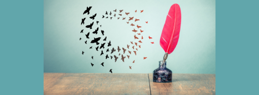 A wooden desk with an ink bottle and a red feather quill in it. A flock of birds swirls in the background.