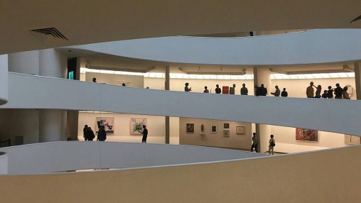 People walking on three levels of the NYC Guggenheim Museum gallery ramps