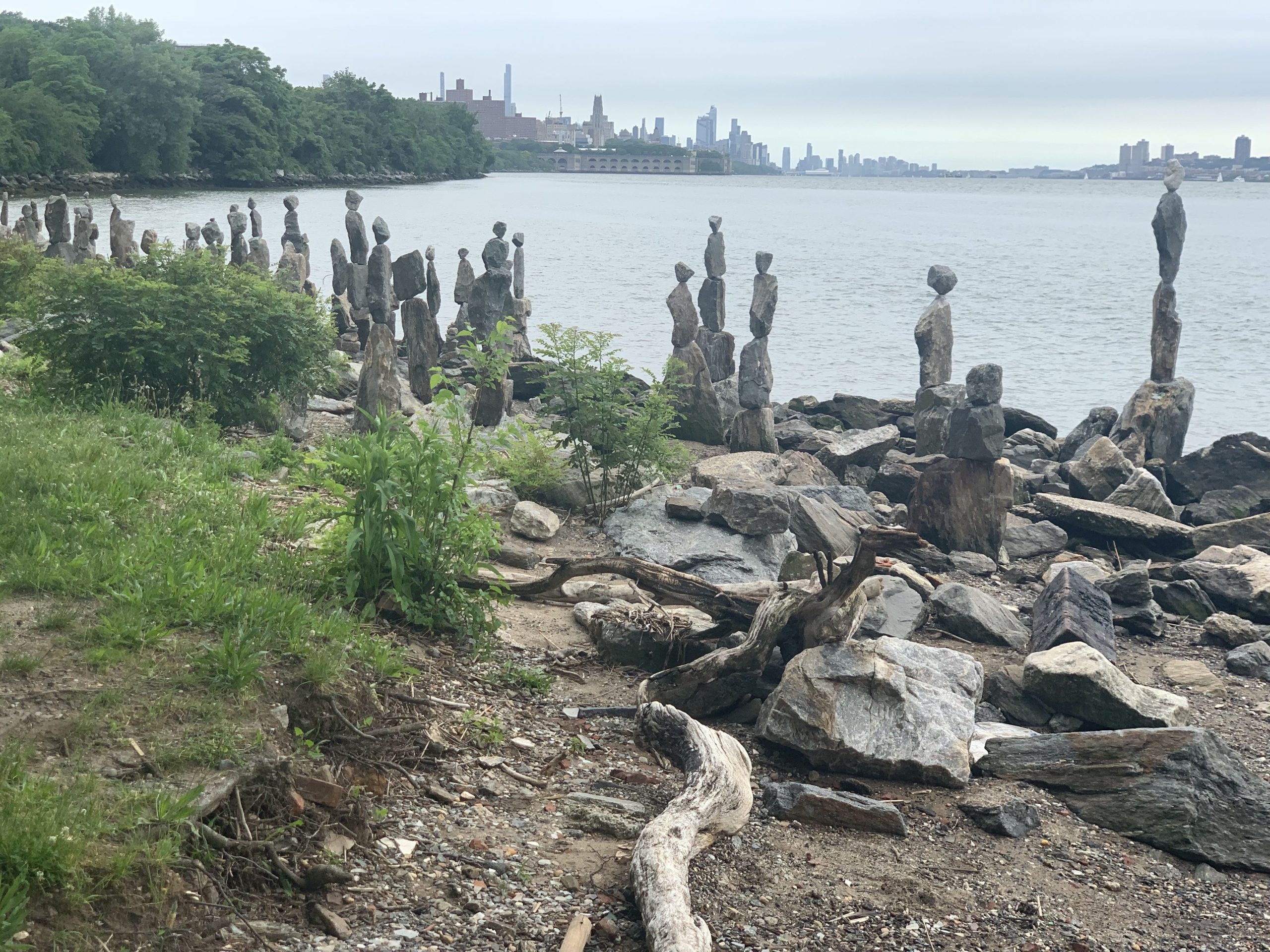 piles of rocks by the water piled by an artist