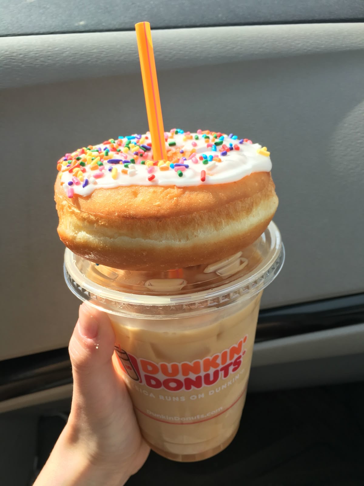Iced coffee with donut on top. 