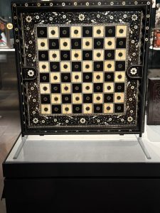 Close-up of chessboard at the Met, with black and cream squares.
