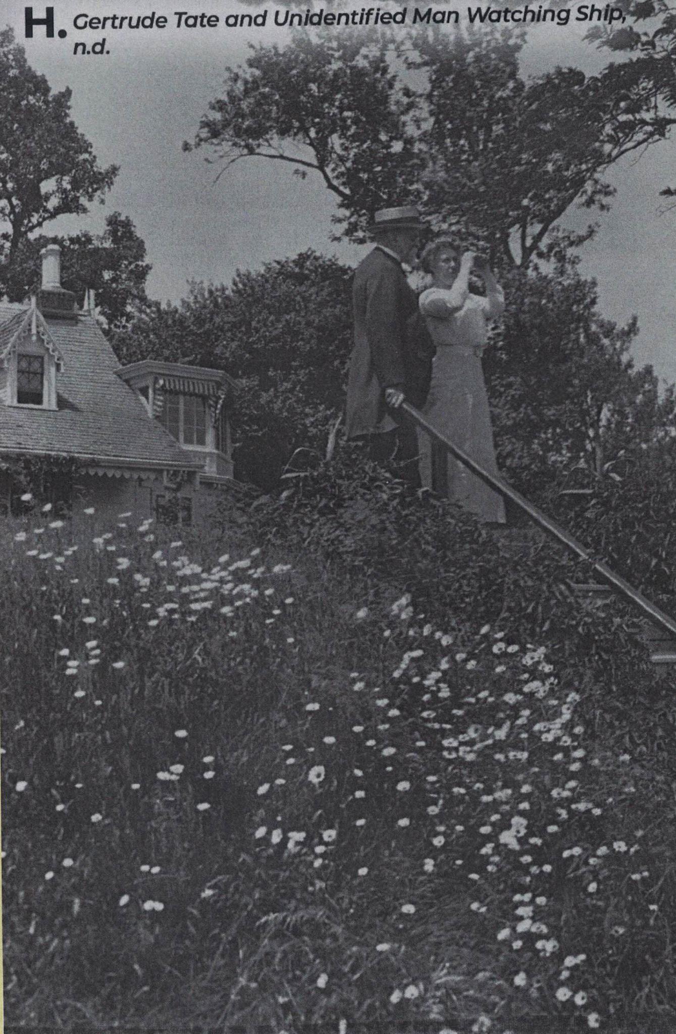 Black and white photograph by Alice Austen of Gertrude Tate and an unidentified man standing at the top of a staircase