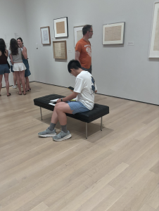 Guy looking at Duchamp book he bought in gift shop