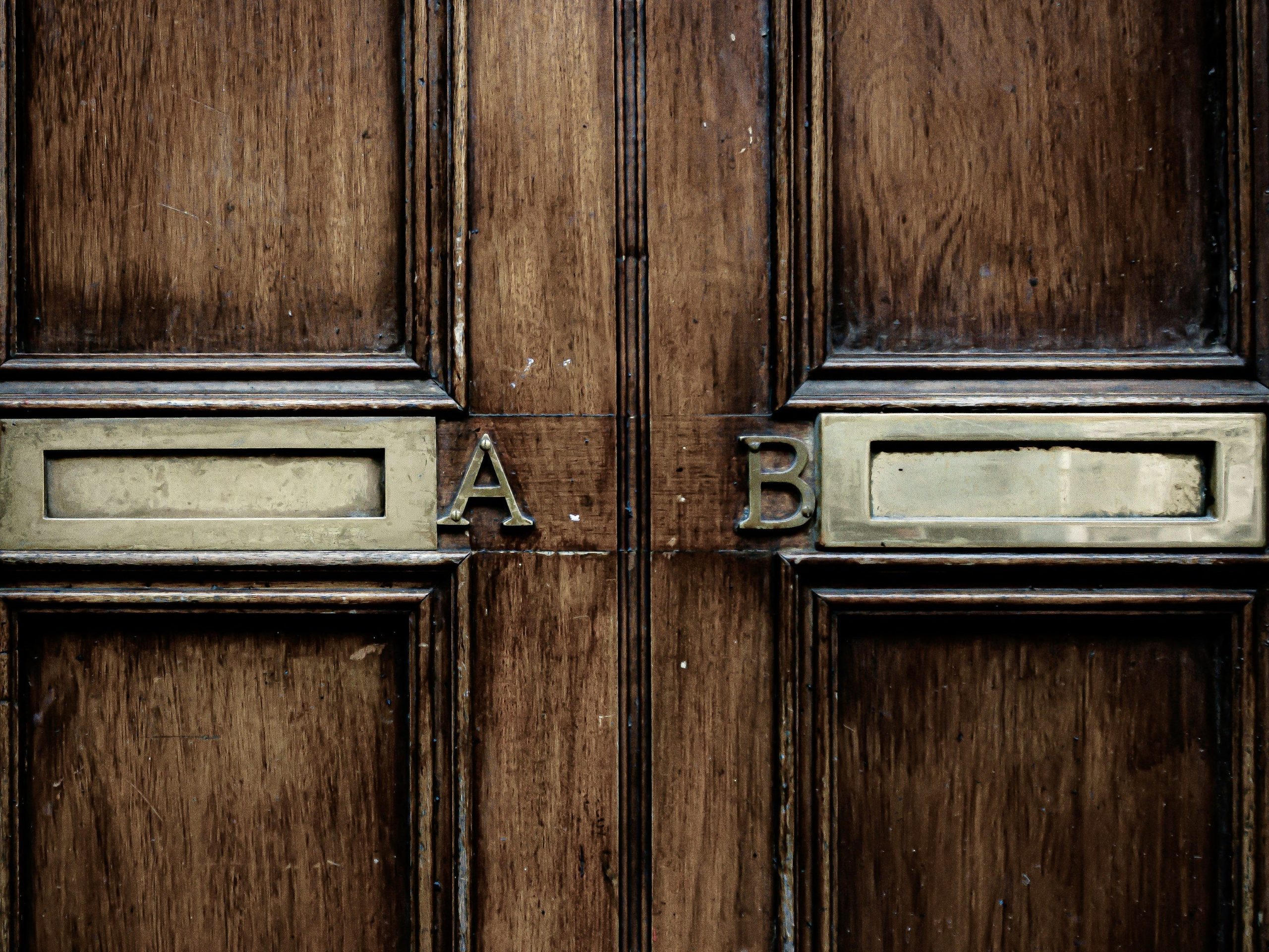 Door showing two mail slots, one on the left labeled A, and the one on the right labeled B.