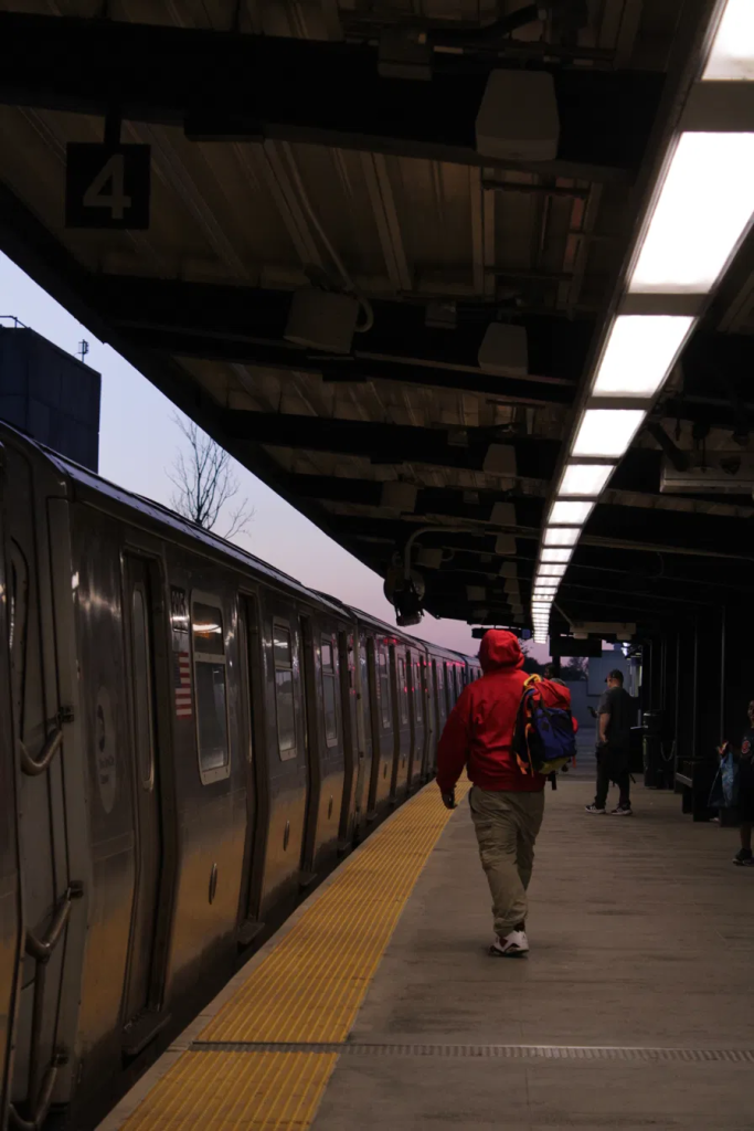 A train arrived at Broad Channel stop, Man with red hoodie walking towards train - Taken by Vina Chen
