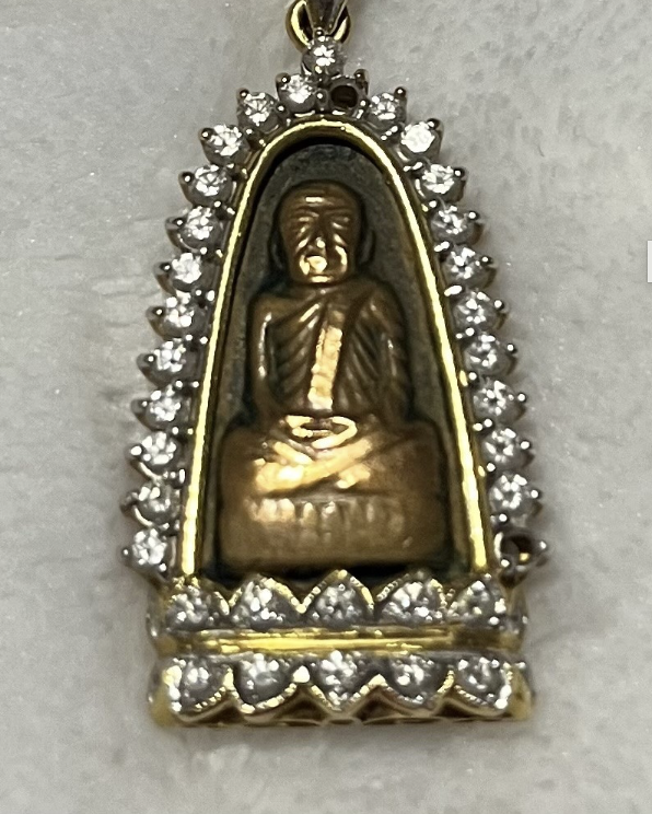 The Buddha necklace is adorned with diamonds and there's a solid gold Buddha carving in the center.